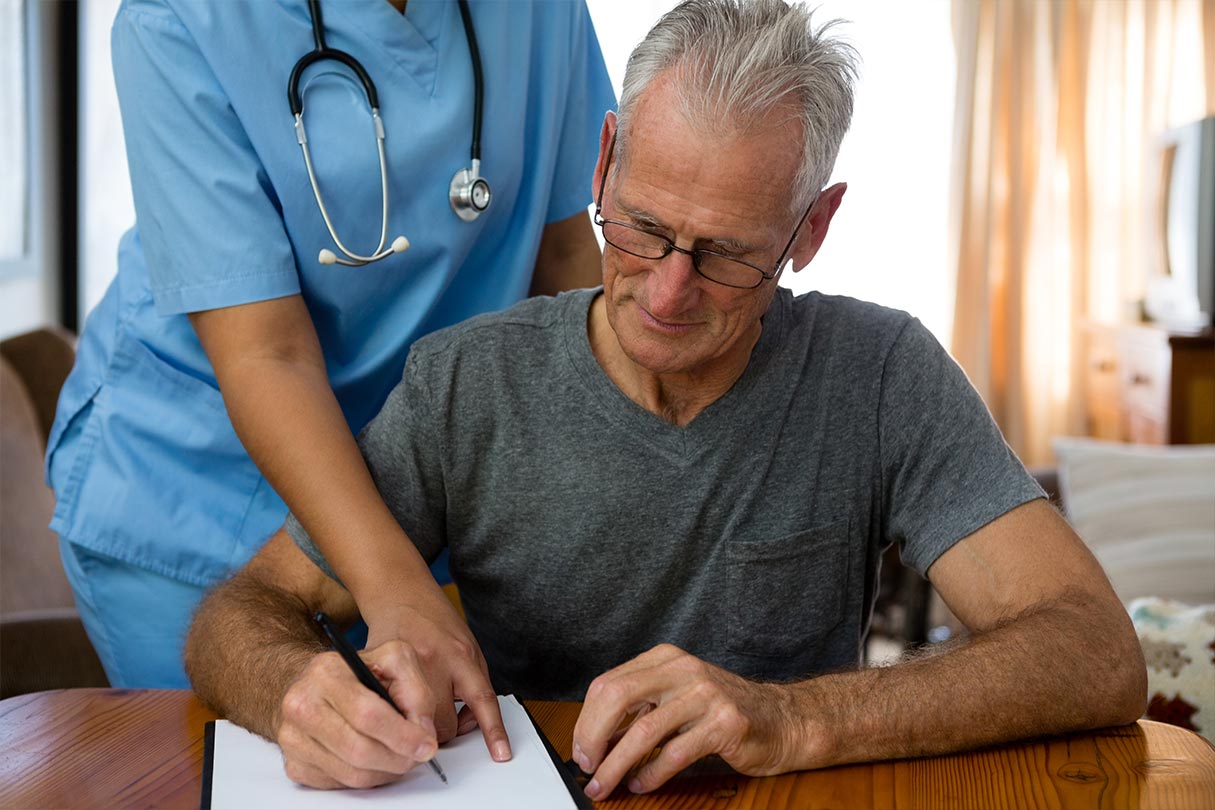 Man signing paper for final expenses